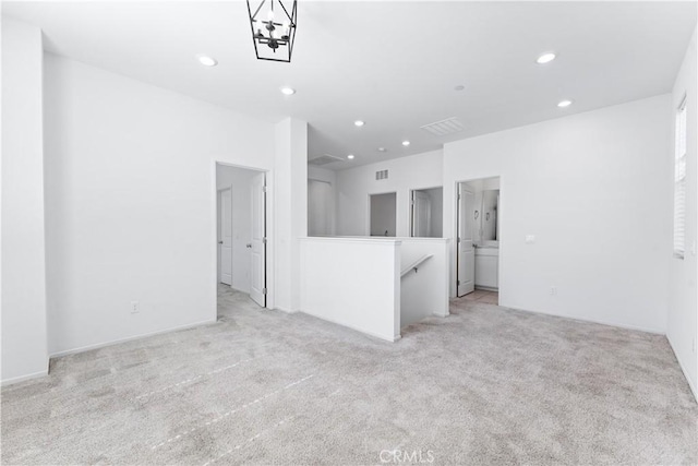 spare room featuring recessed lighting, visible vents, and light colored carpet