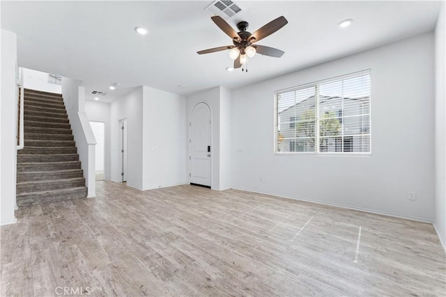 unfurnished living room with recessed lighting, visible vents, light wood-style flooring, stairway, and a ceiling fan