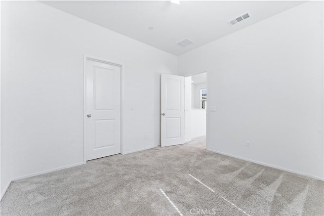 unfurnished bedroom featuring baseboards, visible vents, and carpet flooring