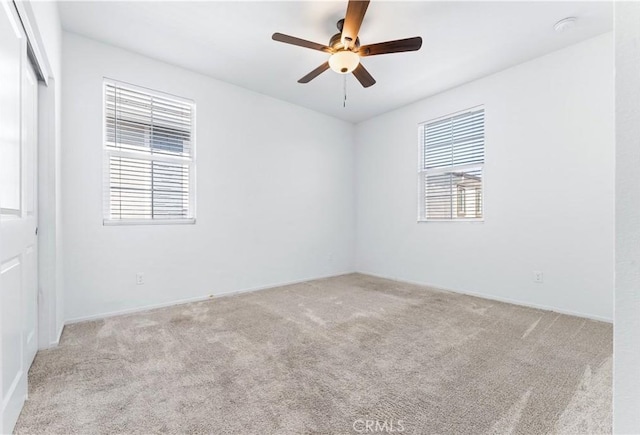 carpeted empty room with ceiling fan