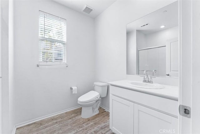 full bath with visible vents, toilet, an enclosed shower, vanity, and wood finished floors