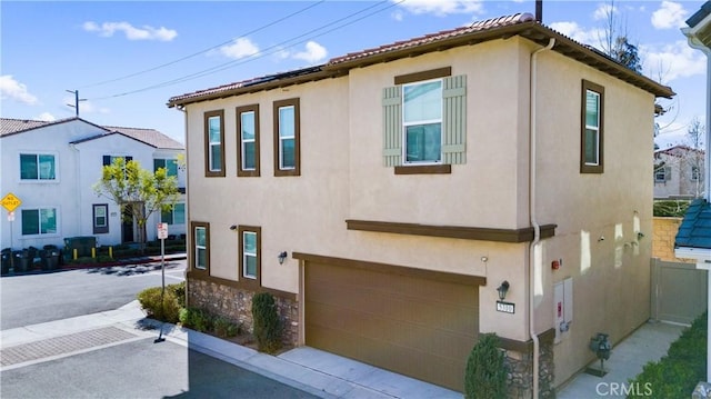 view of front of house with an attached garage and stucco siding