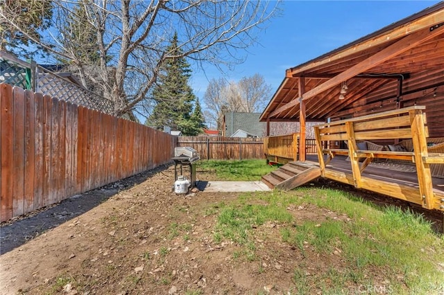 view of yard with a fenced backyard and a deck