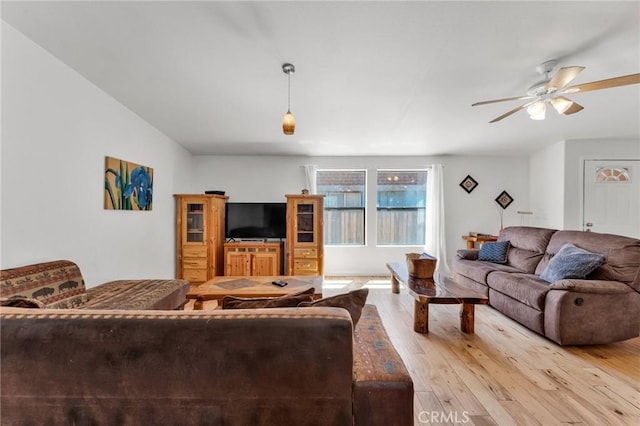 living room with ceiling fan and light wood-style floors