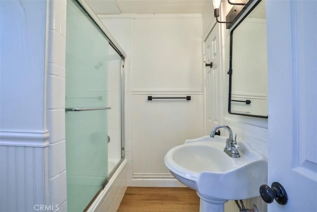3255 N Arrowhead Ave, San Bernardino, CA 92405 - full bathroom with a sink, combined bath / shower with glass door, a decorative wall, wainscoting, and wood finished floors