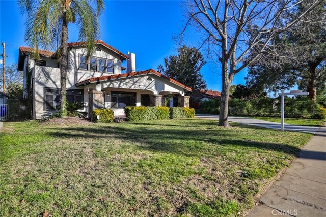 3255 N Arrowhead Ave, San Bernardino, CA 92405 - mediterranean / spanish-style home featuring a tile roof, a front lawn, and stucco siding
