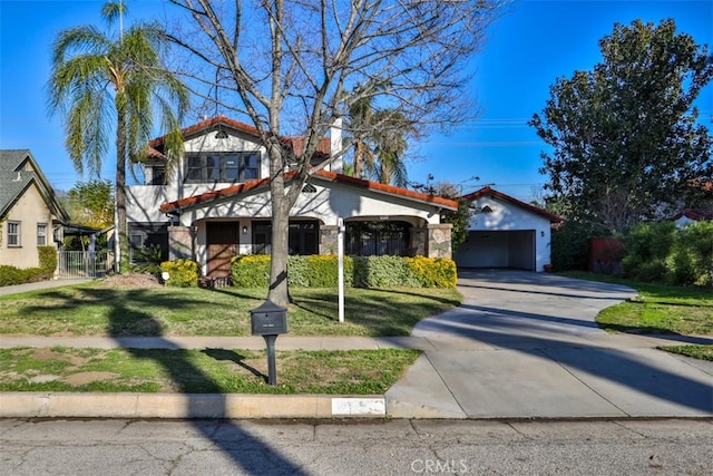 view of front of house with concrete driveway, a tile roof, a front lawn, and stucco siding