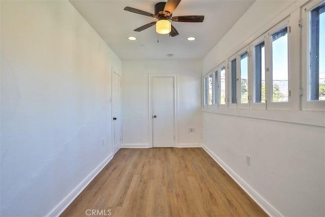 spare room with light wood-type flooring, recessed lighting, ceiling fan, and baseboards