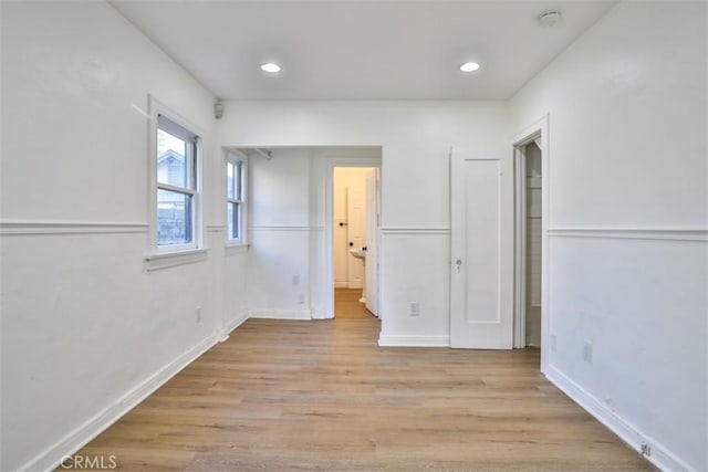 unfurnished bedroom featuring recessed lighting, baseboards, connected bathroom, and light wood finished floors