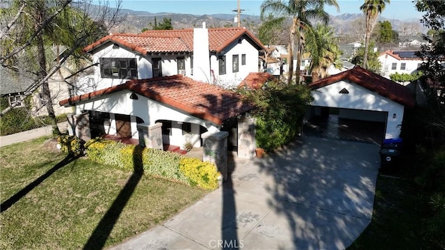 3255 N Arrowhead Ave, San Bernardino, CA 92405 - view of front of property with stucco siding, a tiled roof, a mountain view, and a garage