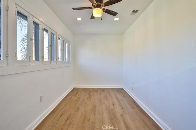 unfurnished room featuring recessed lighting, a ceiling fan, visible vents, baseboards, and light wood-type flooring