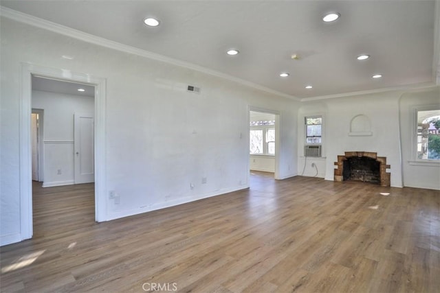 unfurnished living room featuring visible vents, wood finished floors, crown molding, a fireplace, and recessed lighting