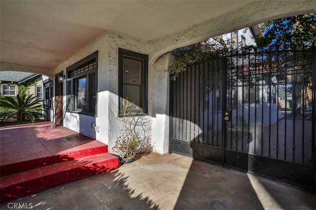 exterior space featuring a gate and stucco siding