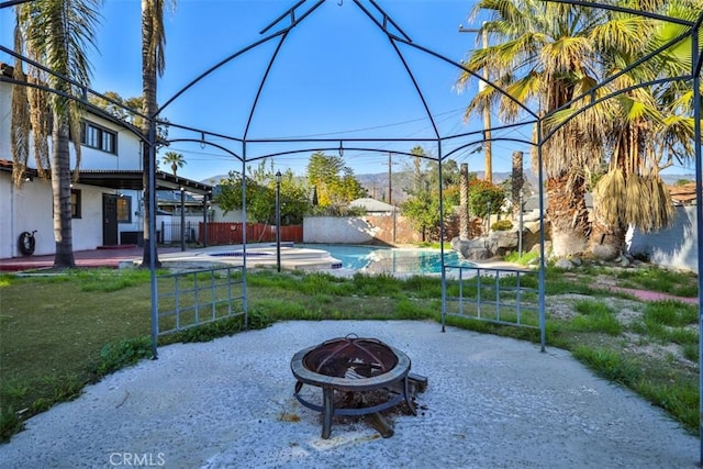 3255 N Arrowhead Ave, San Bernardino, CA 92405 - view of patio / terrace with a fire pit, fence, and a fenced in pool