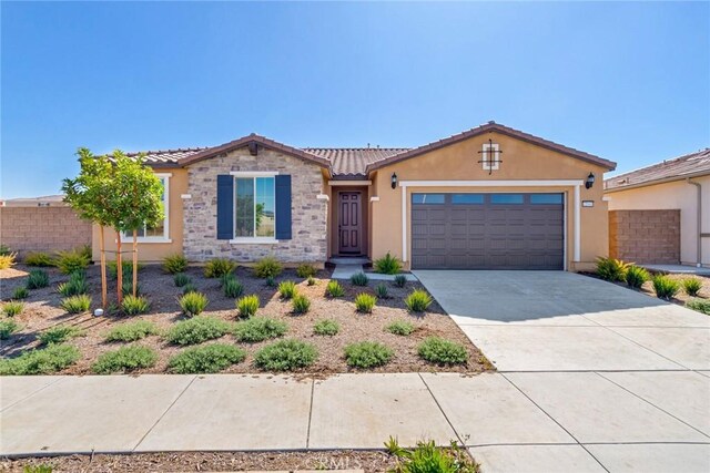 12945 Big Valley Ct, Riverside, CA 92503 - view of front facade with stucco siding, fence, a tile roof, an attached garage, and concrete driveway
