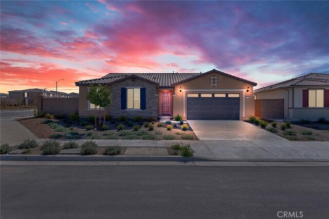 12945 Big Valley Ct, Riverside, CA 92503 - view of front of house with a tiled roof, stucco siding, fence, an attached garage, and concrete driveway