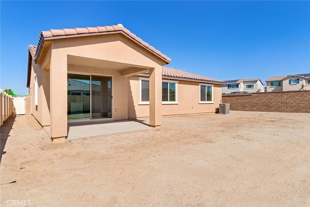 12945 Big Valley Ct, Riverside, CA 92503 - rear view of house with a fenced backyard, a tile roof, a patio, and stucco siding