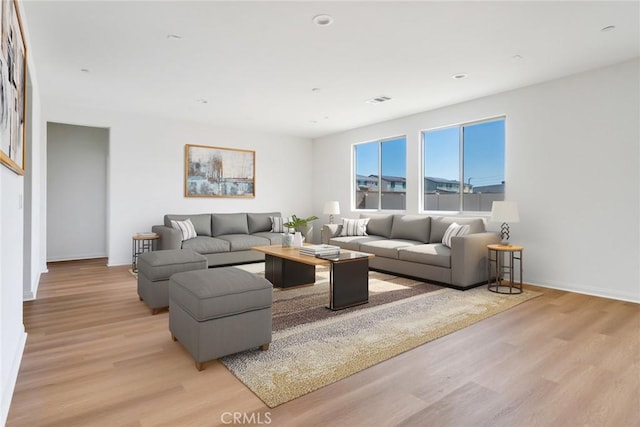 12945 Big Valley Ct, Riverside, CA 92503 - living area with visible vents, baseboards, and light wood-style floors
