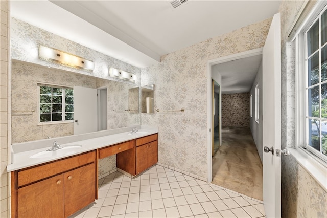 bathroom featuring double vanity, a sink, and wallpapered walls