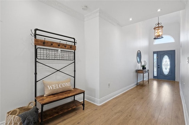 entrance foyer featuring recessed lighting, wood-type flooring, and baseboards