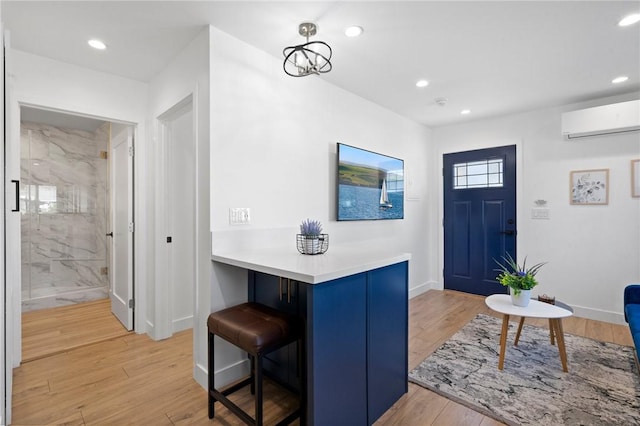 foyer entrance featuring light wood-type flooring, recessed lighting, baseboards, and a wall mounted AC