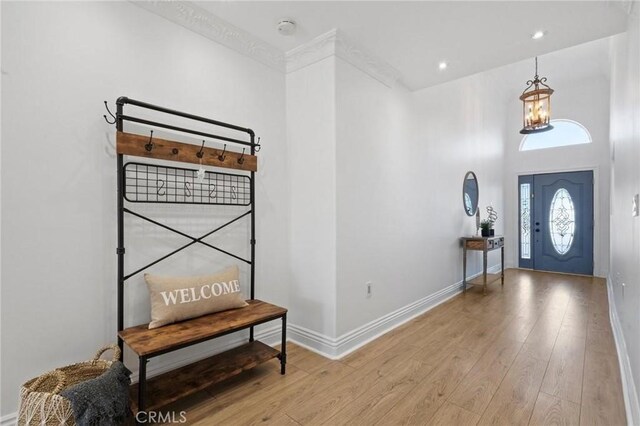 entryway featuring recessed lighting, wood-type flooring, and baseboards