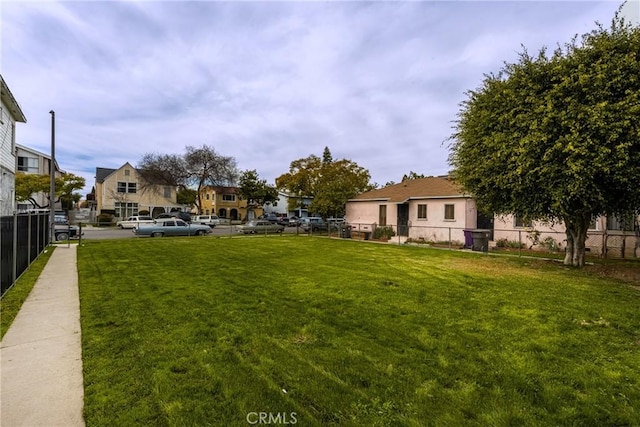 view of yard with a residential view and fence