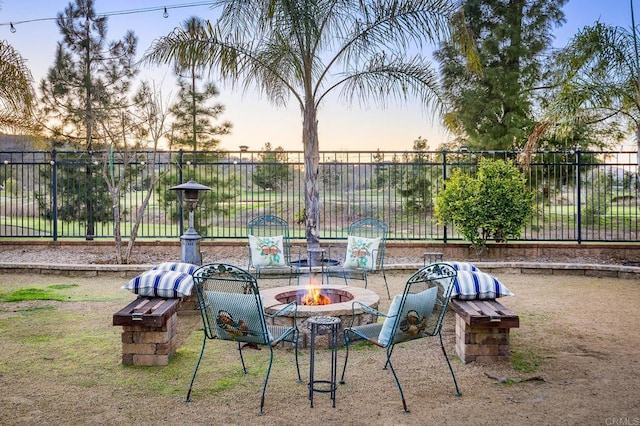 view of yard with fence and a fire pit