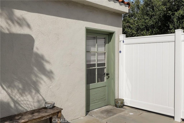 entrance to property featuring stucco siding