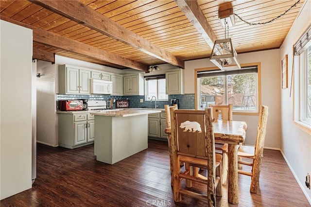 kitchen featuring white appliances, a kitchen island, a sink, and decorative backsplash