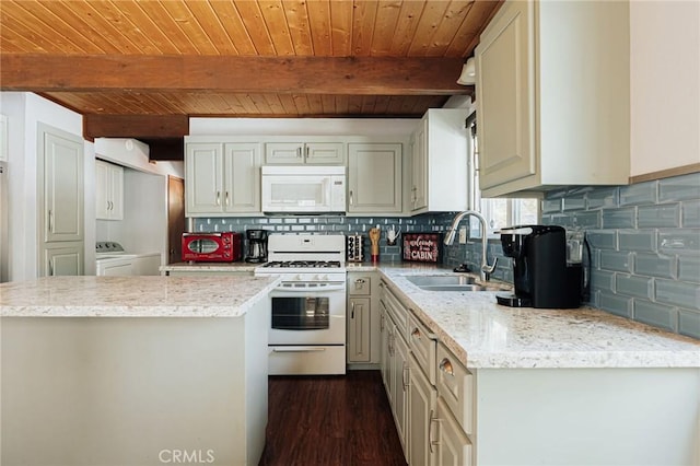 kitchen featuring white appliances, decorative backsplash, wooden ceiling, washing machine and clothes dryer, and a sink