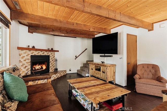 living area with beam ceiling, a brick fireplace, wood ceiling, wood finished floors, and stairs