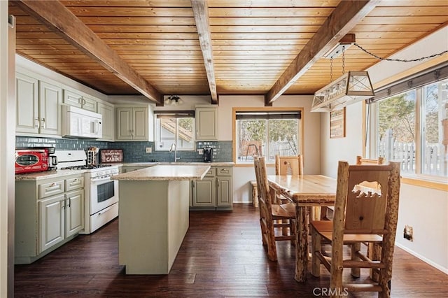 kitchen with tasteful backsplash, white appliances, light countertops, and dark wood finished floors