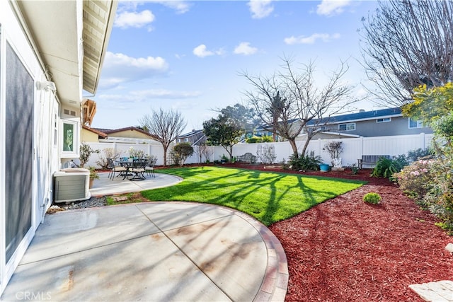 view of yard featuring a fenced backyard, a patio, and central air condition unit