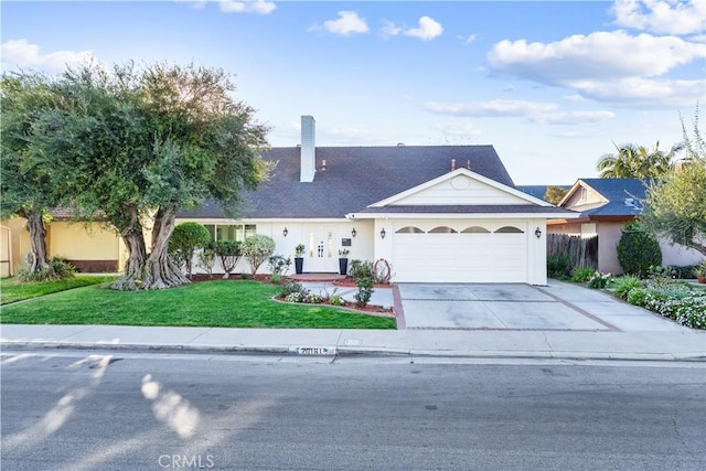 view of front of property with an attached garage, stucco siding, concrete driveway, and a front yard