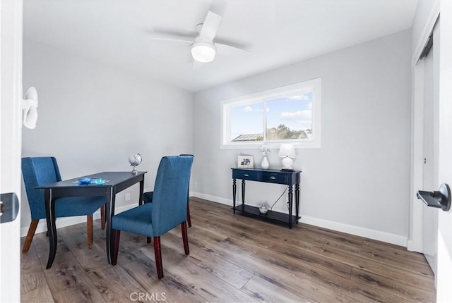 office area with ceiling fan, baseboards, and wood finished floors