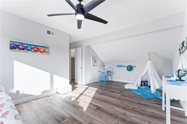 bonus room featuring lofted ceiling, visible vents, baseboards, and wood finished floors