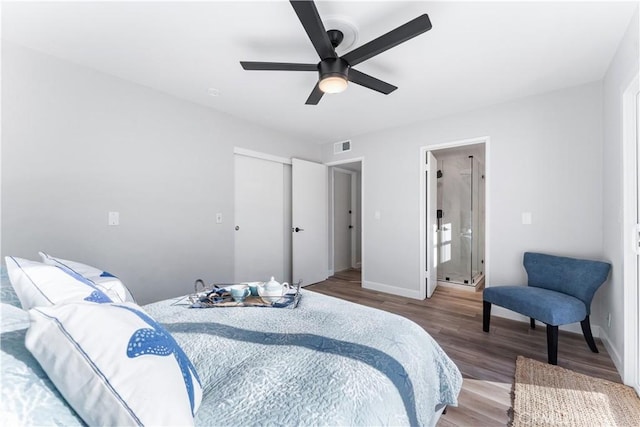 bedroom featuring visible vents, baseboards, ceiling fan, wood finished floors, and a closet