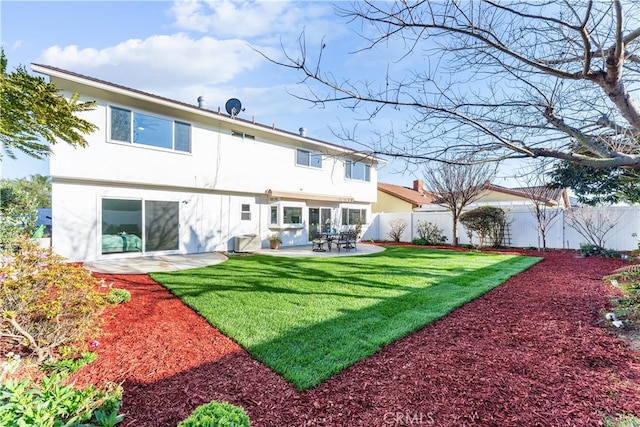 back of property featuring a patio, a yard, a fenced backyard, and stucco siding