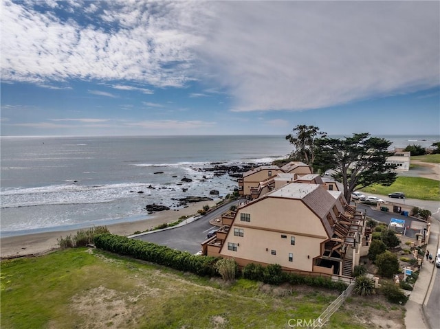 birds eye view of property featuring a water view and a view of the beach