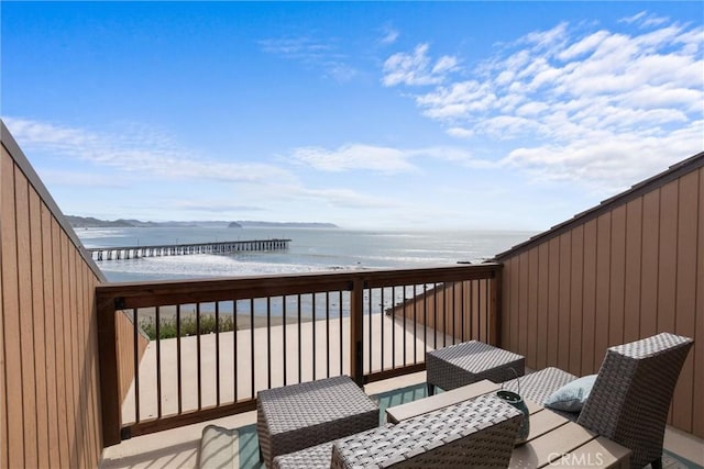 deck featuring a water view and a beach view