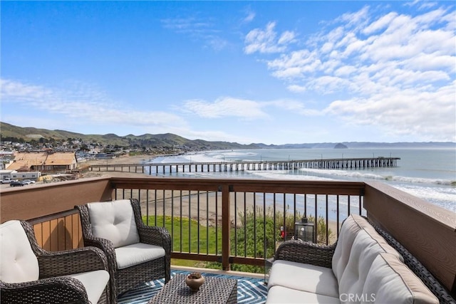 wooden deck featuring an outdoor living space and a water and mountain view