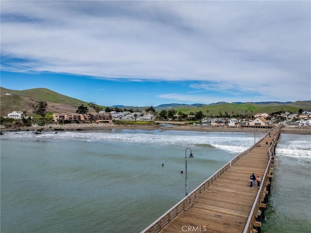 view of dock with a water and mountain view