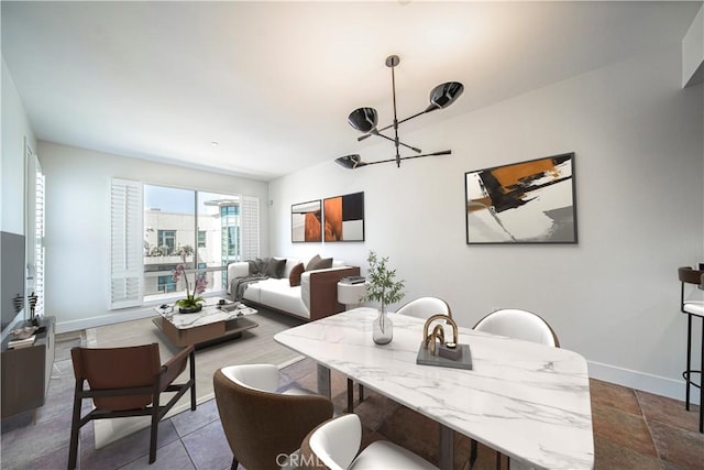 dining space with a notable chandelier and baseboards