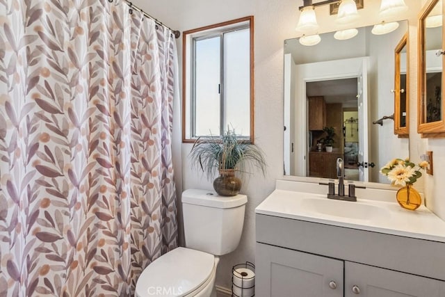 full bath featuring a shower with curtain, vanity, and toilet