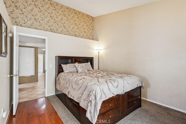 bedroom featuring baseboards and wood finished floors