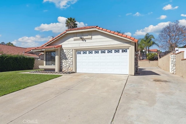 mediterranean / spanish-style house with concrete driveway, a front yard, fence, a garage, and a tiled roof