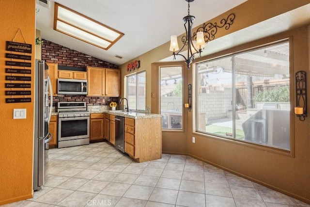 kitchen with pendant lighting, light tile patterned floors, tasteful backsplash, lofted ceiling, and appliances with stainless steel finishes