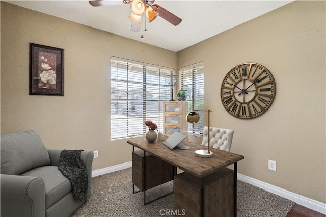 office space featuring ceiling fan and baseboards