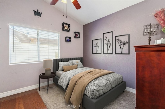 bedroom featuring lofted ceiling, ceiling fan, baseboards, and wood finished floors